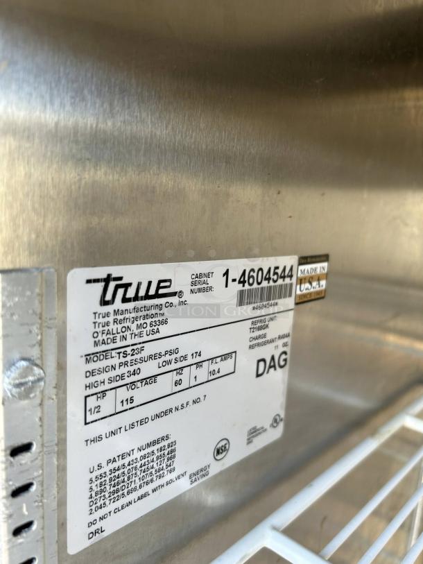 True TS-23F-HC reach-in freezer label showing model, voltage (115v), and pressure specs; tested and working.