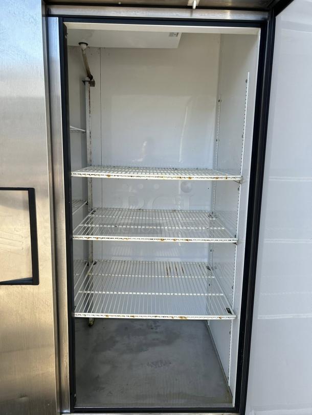 True T-49-HC 54" solid door reach-in refrigerator, tested and working, features wire shelving and stainless exterior.