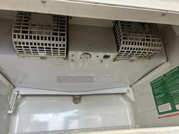 Turbo Air TGM-22RV(B)-N6 commercial cooler interior, showing cooling system, temperature control knob, and safety labels.