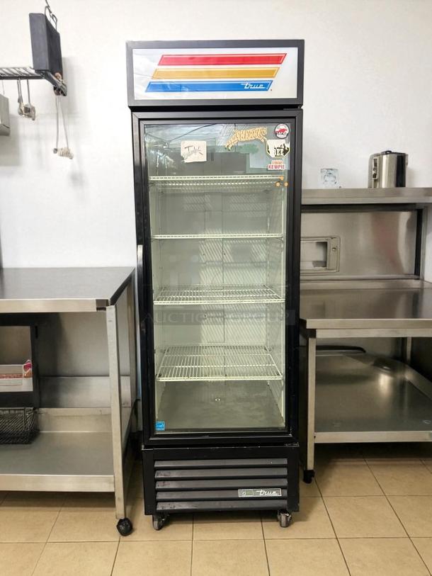 True GDM-23-HC~TSL01 glass door merchandiser, 27", black, tested, working, left-hinged, excellent condition, visible branding.