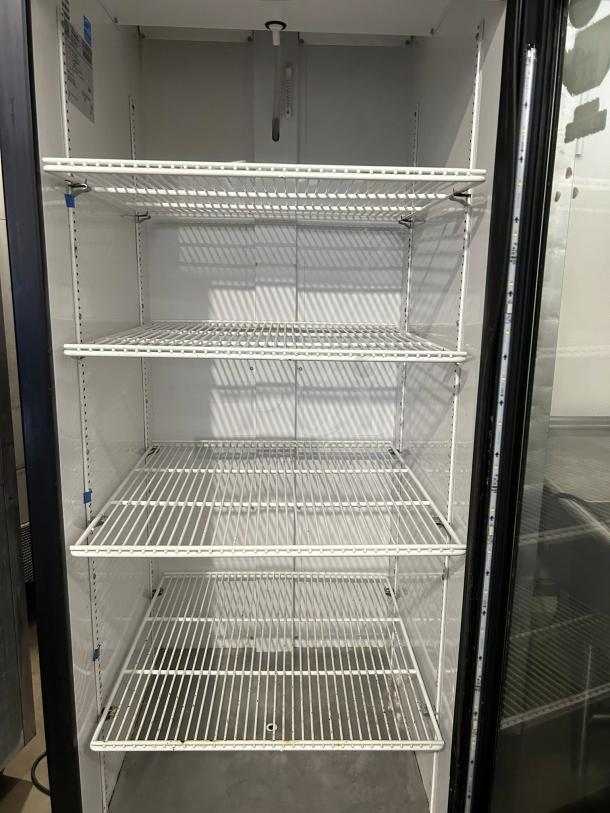 True GDM-23-HC~TSL01, 27" black refrigerated glass door merchandiser in great condition with four shelves, left-hinged.