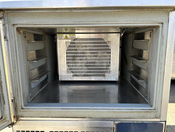 Alto-Shaam QC3-3 27" Quickchiller in excellent condition, tested and working. Interior view shows metal shelves and caution labels.