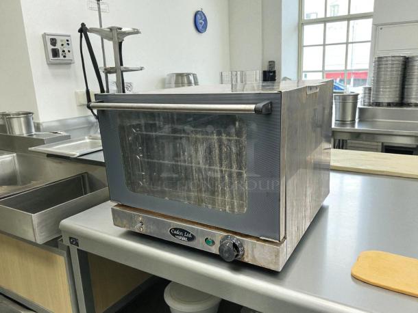 Cadco OV-250 quarter size electric convection oven, stainless steel, tested, working, great condition, visible control knobs.