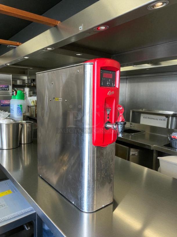 Curtis WB5N hot water dispenser, 5 gal capacity, stainless steel, red accents, digital display, excellent condition.