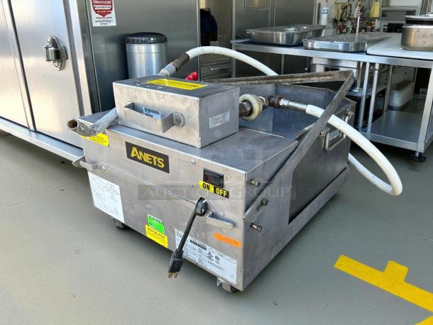 Anets FFM80 80 lb commercial fryer filter, gravity-fed, 120v, tested and working, features on/off switch and labeled hoses.