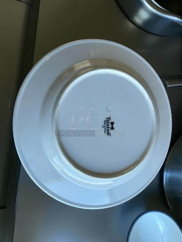 Tuxton 10 1/2” white dining plate in great condition. Marked with "Tuxton" logo. Durable stoneware, excellent find.
