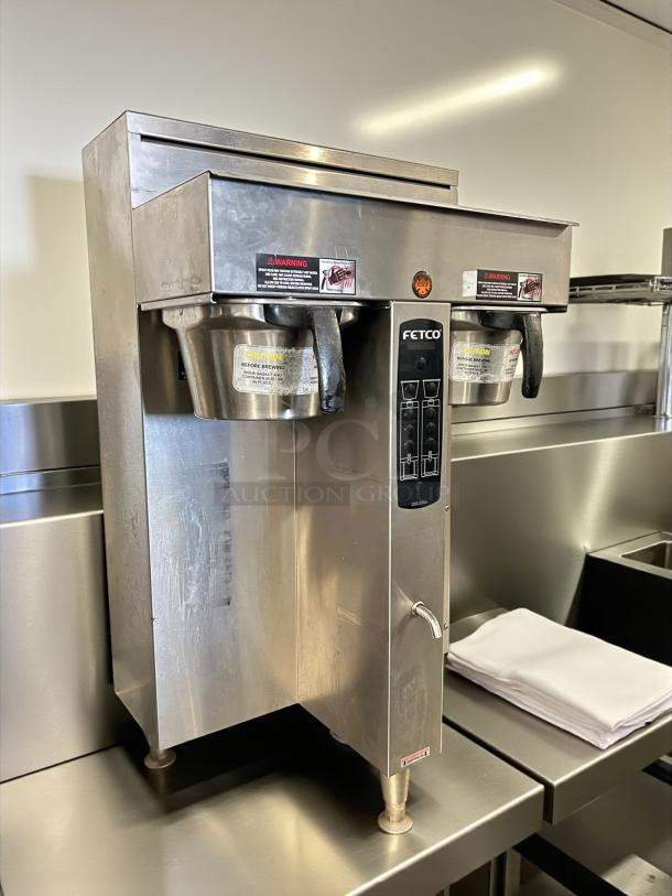 Fetco CBS-2042e E42016 twin 1-gallon coffee brewer in stainless steel, tested and working, warning labels visible.