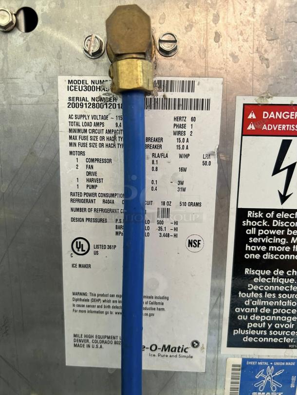 Ice-O-Matic ICEU300FA ice machine label showing model, serial number, voltage, refrigerant type, and certification logos.