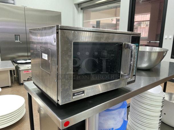 Sharp R-22GTF Commercial Microwave Oven, 1200 watts, stainless steel, tested and working, visible control panel, sturdy handle.