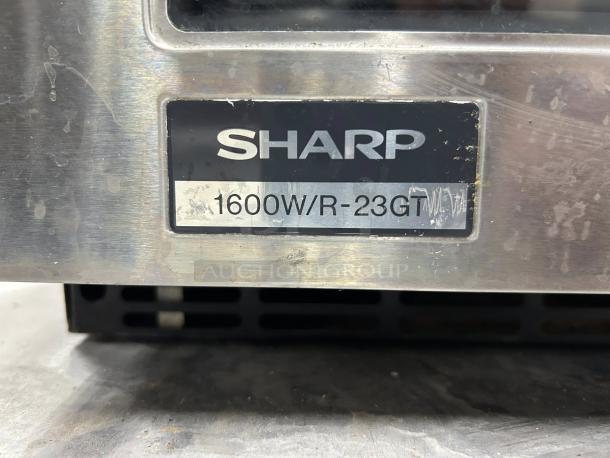 Sharp R-23GT Commercial Microwave, 1600W, stainless steel label, tested and working. Signs of use visible on surface.