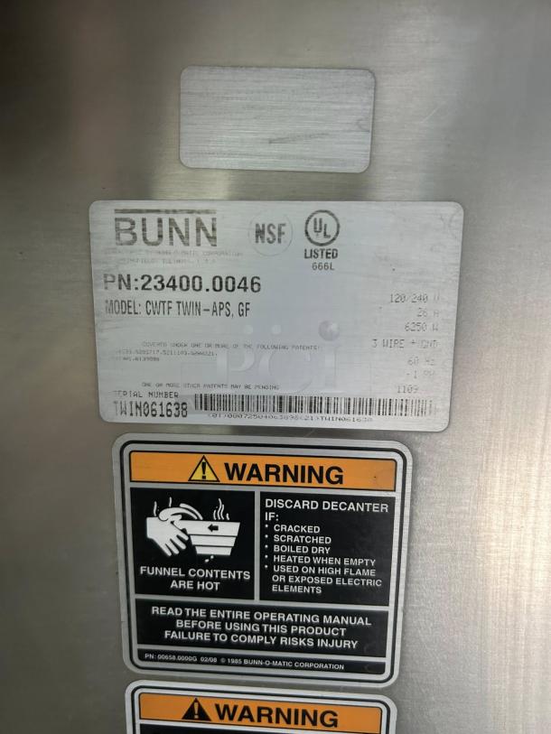 Bunn CWTF-TWIN-APS coffee brewer label with model and serial numbers, NSF and UL listed, warning instructions visible.