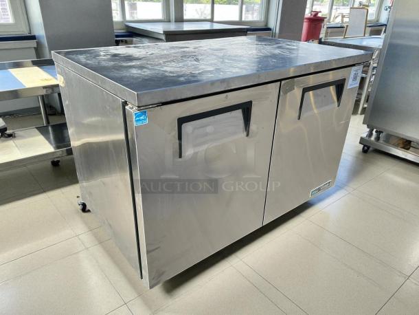 True TUC-48-C-HC 48" stainless steel undercounter refrigerator, like new condition, two doors, with energy efficiency label.