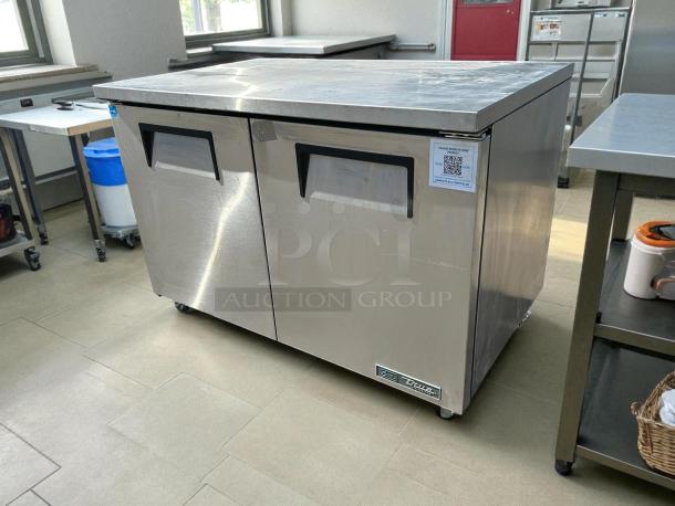 True TUC-48-C-HC 48" stainless steel undercounter refrigerator, like new, dual doors, pristine condition, model label visible.