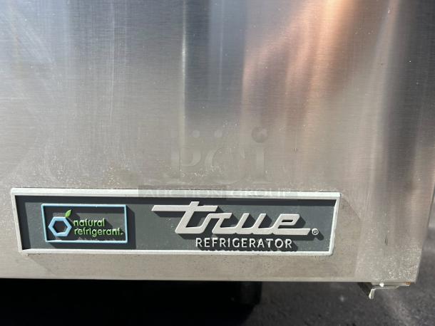 True TUC-48-C-HC 48" stainless steel 2-door undercounter refrigerator. Like new condition. Natural refrigerant label visible.