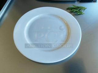 Tuxton 10 1/2” white dining plate in excellent condition, smooth finish, ideal for elegant dining.