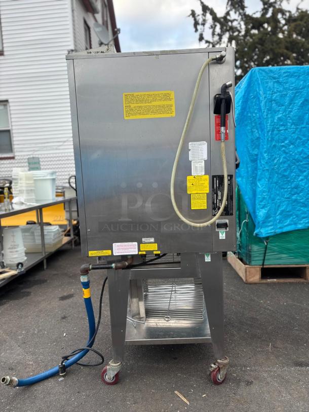 Cleveland Combi Oven-Steamer OGB-10, stainless steel, attached hoses, visible instruction labels, mounted on wheels.