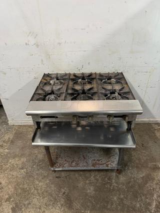 COMMERCIAL 36" 6 burner range, metal construction, used condition with visible wear, dual shelf, ideal for high-volume kitchens.