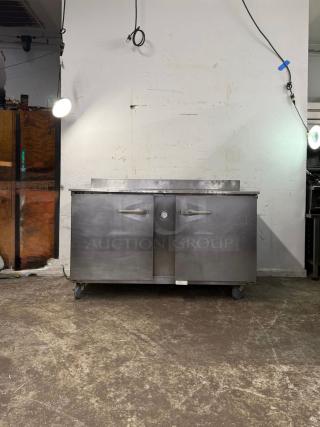 Traulsen UHT60-LR 60" undercounter refrigerator, two sections, two doors, 115v, stainless steel, mounted on casters.