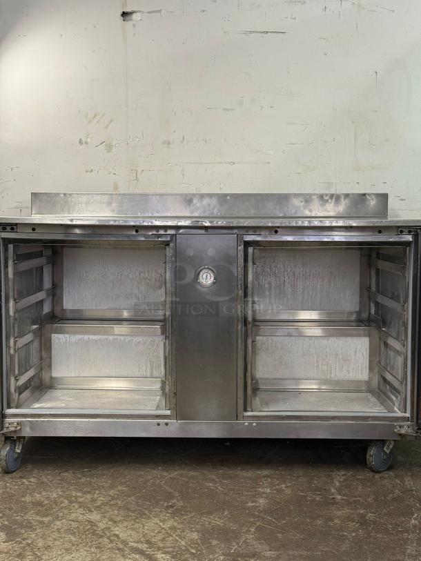 Traulsen UHT60-LR 60" undercounter refrigerator, two sections, two doors, worn condition, visible thermometer, on casters.