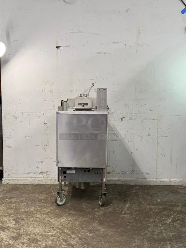 Wells KFC pressure fryer, stainless steel, on casters, industrial-grade, used condition, model and serial number visible.