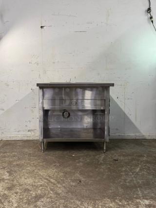Stainless steel STEEM TABLE 3 WELL, commercial-grade, in good condition. Features durable construction with open storage.