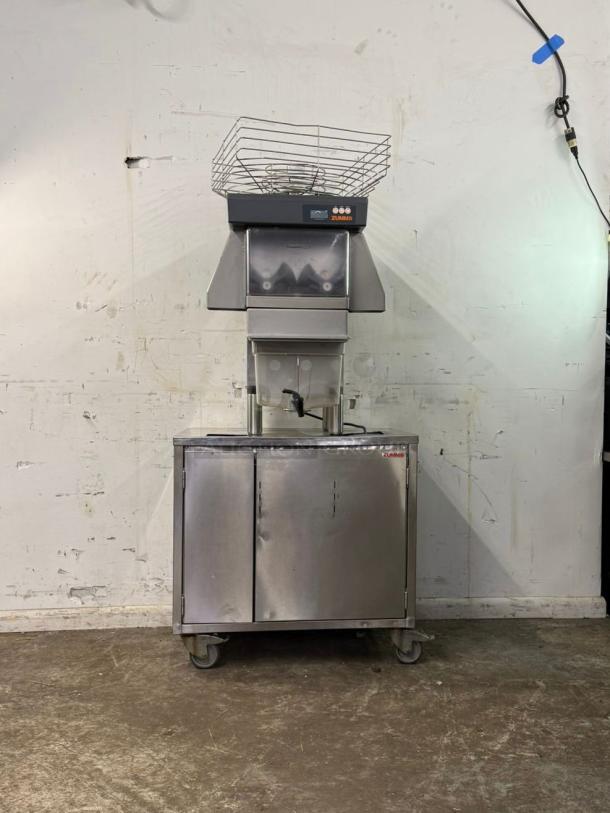 Zummo Z40-N-LM citrus juicer, 290W, 120v, automatic feed, processes 25 fruits/minute. Stainless steel, mobile base, good condition.