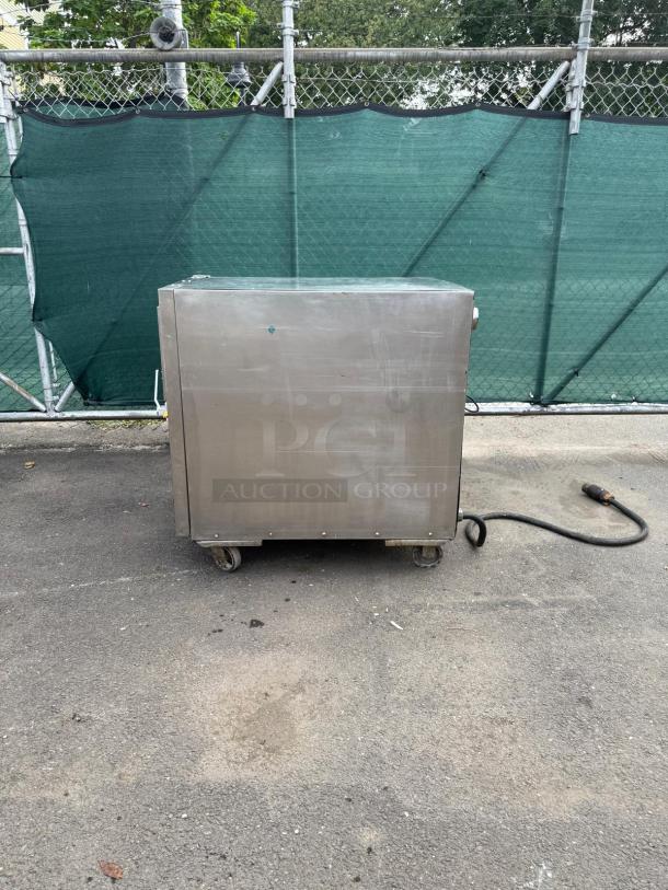 OLIVER 690-NC2 stainless steel commercial electric machine, on wheels, outdoor setting, fair condition, cord attached.