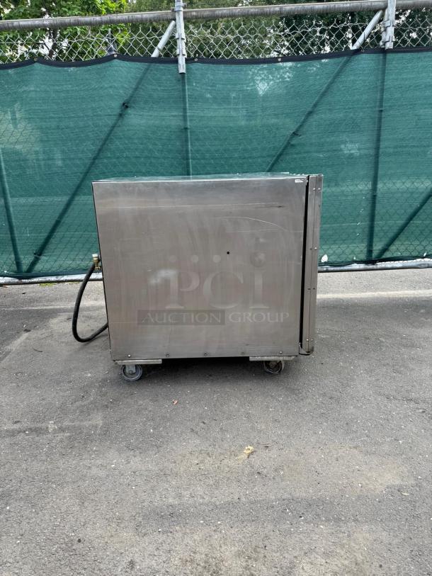 OLIVER 690-NC2 stainless steel commercial electric appliance, on wheels, showing minor wear, suitable for heavy-duty use.