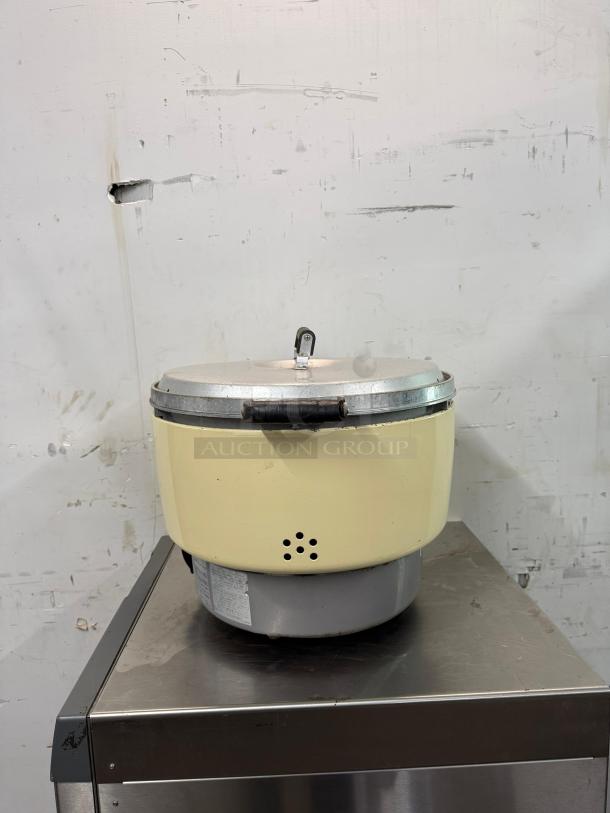 Rinnai RER55ASN 55 Cup Commercial Natural Gas Rice Cooker, metal body, lightly used condition, visible instruction label.