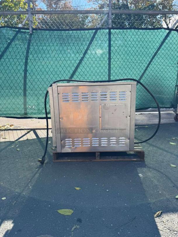 Bakers Pride EP-2-2828 double deck electric pizza oven, stainless steel, on a pallet, exterior view, used condition.