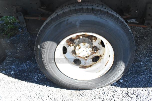 Tire of 2004 Izuzu Morgan Diesel Reefer Box Truck with visible rust on rim, odometer reads 215,769.