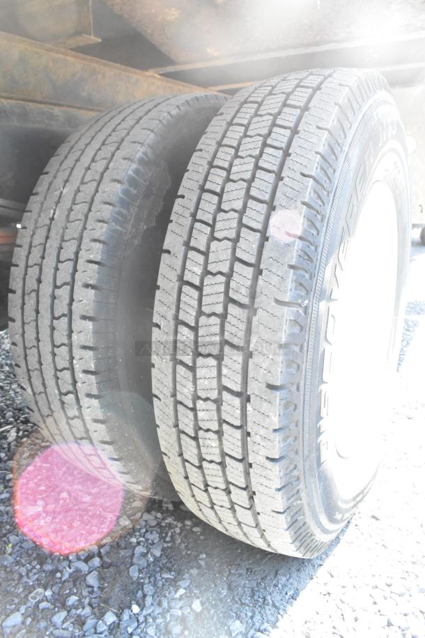 Close-up of rear tires on a 2004 Isuzu Morgan Diesel Reefer Box Truck. Odometer: 215,769 miles. Good tread condition.
