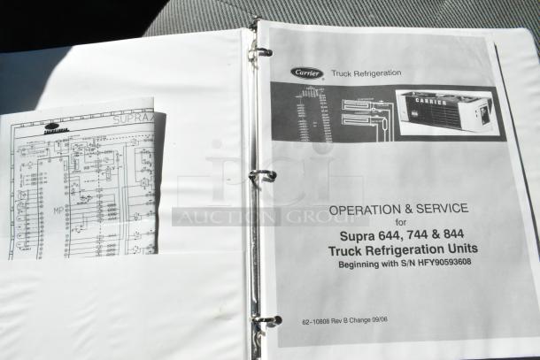 Carrier Transicold refrigeration manual for Supra units; includes operation, service instructions, and schematics in a binder.