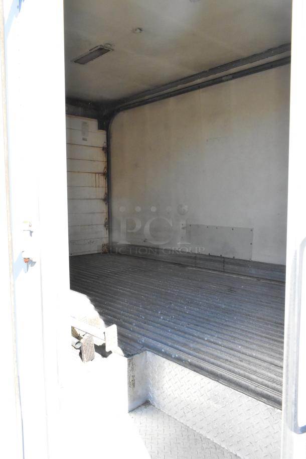 2004 Izuzu Morgan Diesel Reefer Box Truck interior with Carrier Transicold system. Visible wear on interior walls and floor.