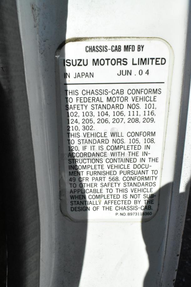Label on 2004 Isuzu Morgan Diesel Reefer Box Truck with Carrier Transicold system, conforming to various federal safety standards.