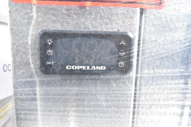 Copeland control panel on Amerikooler DW081677F-8/8-SC walk-in freezer/cooler, wrapped in protective plastic.