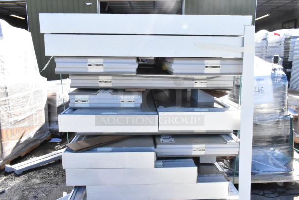 BRAND NEW SCRATCH AND DENT Amerikooler 8' x 16' x 7' 7" walk-in freezer/cooler panels, stacked outdoors.