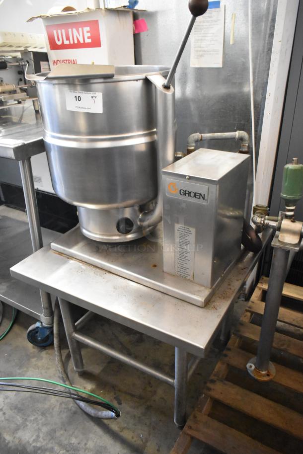 Groen TDB/7-40 stainless steel 10-gallon manual tilt steam kettle on equipment stand. Visible label indicates model and use.
