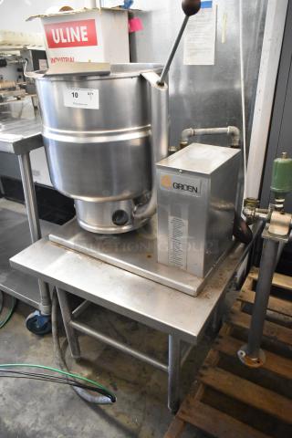 Groen TDB/7-40 stainless steel 10-gallon manual tilt steam kettle on equipment stand. Visible label indicates model and use.