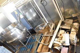 Stainless steel commercial floor kettle with agitator on pallet. Good condition, some wiring visible, ideal for high-volume cooking.
