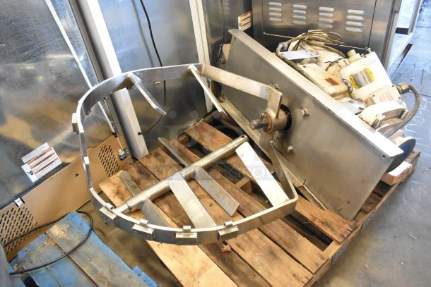 Stainless steel commercial floor-style kettle with agitator, shown on a pallet. Features visible motor and sturdy construction.