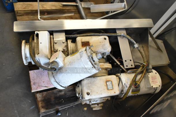 Stainless steel commercial floor-style kettle with agitator, used condition, visible motors and wiring, showing wear from use.