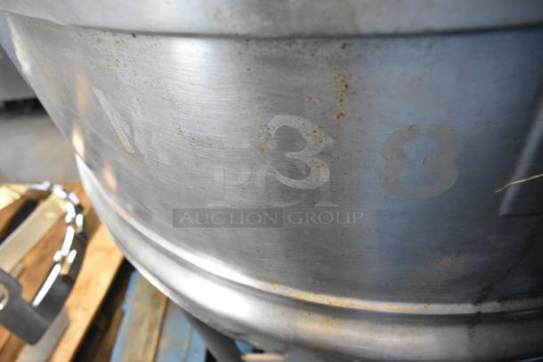 Stainless steel commercial floor-style kettle with agitator, minor rust, markings visible, suitable for large-scale cooking.