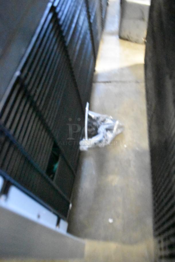 Blurred image of Avantco 193VOA70W commercial merchandiser, showing part of the exterior grill with unclear details.
