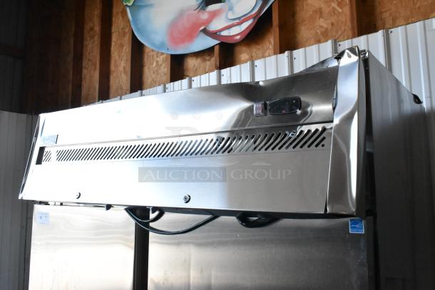 Brand new Avantco 178Z2FHC stainless steel 2-door reach-in freezer with poly-coated racks, visible scratches and dents.