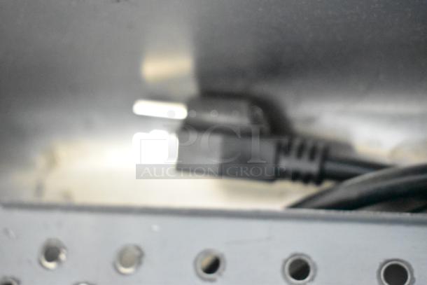 Close-up image of a power cord and plug for the Hatco GRFHS-PT26 Fry Holding Station, showing part of the stainless steel base.