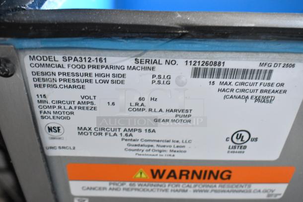 Label of Manitowoc SPA312-161 Ice Dispenser, 115V, 180 lb capacity. Serial No. 1121260881. NSF and UL listed.