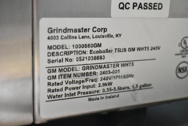 Grindmaster 1000660GM hot water dispenser label showing model, voltage, and manufacturing details. QC passed.