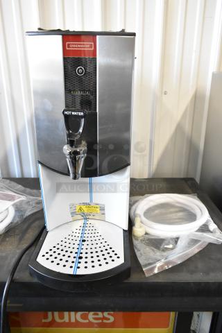 Grindmaster 1000660GM 5.3-gallon hot water dispenser, brand new with minor scratches, tap-operated, 240 volts, caution label visible.