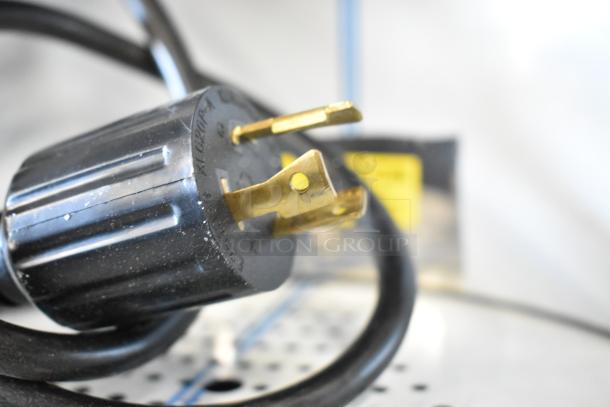Close-up of the power plug for a Grindmaster 1000660GM hot water dispenser, 240 volts, new, minor scratches.